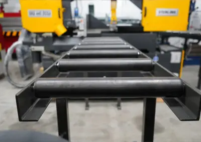 450mm Roller Track, paired with a Sterling Bandsaw in a workshop environment, amongst a range of other machines.