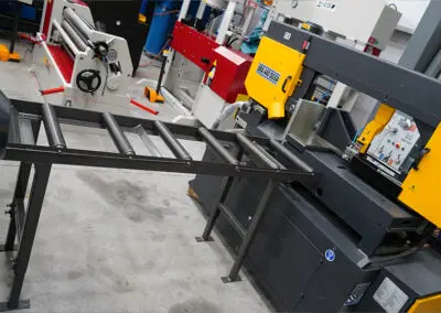 450mm Roller Track, paired with a Sterling Bandsaw in a workshop environment, amongst a range of other machines.