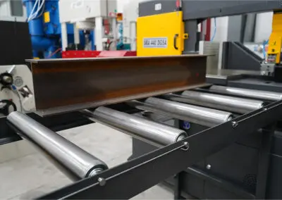 620mm Roller Track, paired with a Sterling Bandsaw in a workshop environment, amongst a range of other machines.