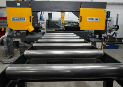 620mm Roller Track, paired with a Sterling Bandsaw in a workshop environment, amongst a range of other machines.