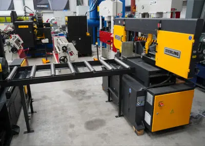 620mm Roller Track, paired with a Sterling Bandsaw in a workshop environment, amongst a range of other machines.